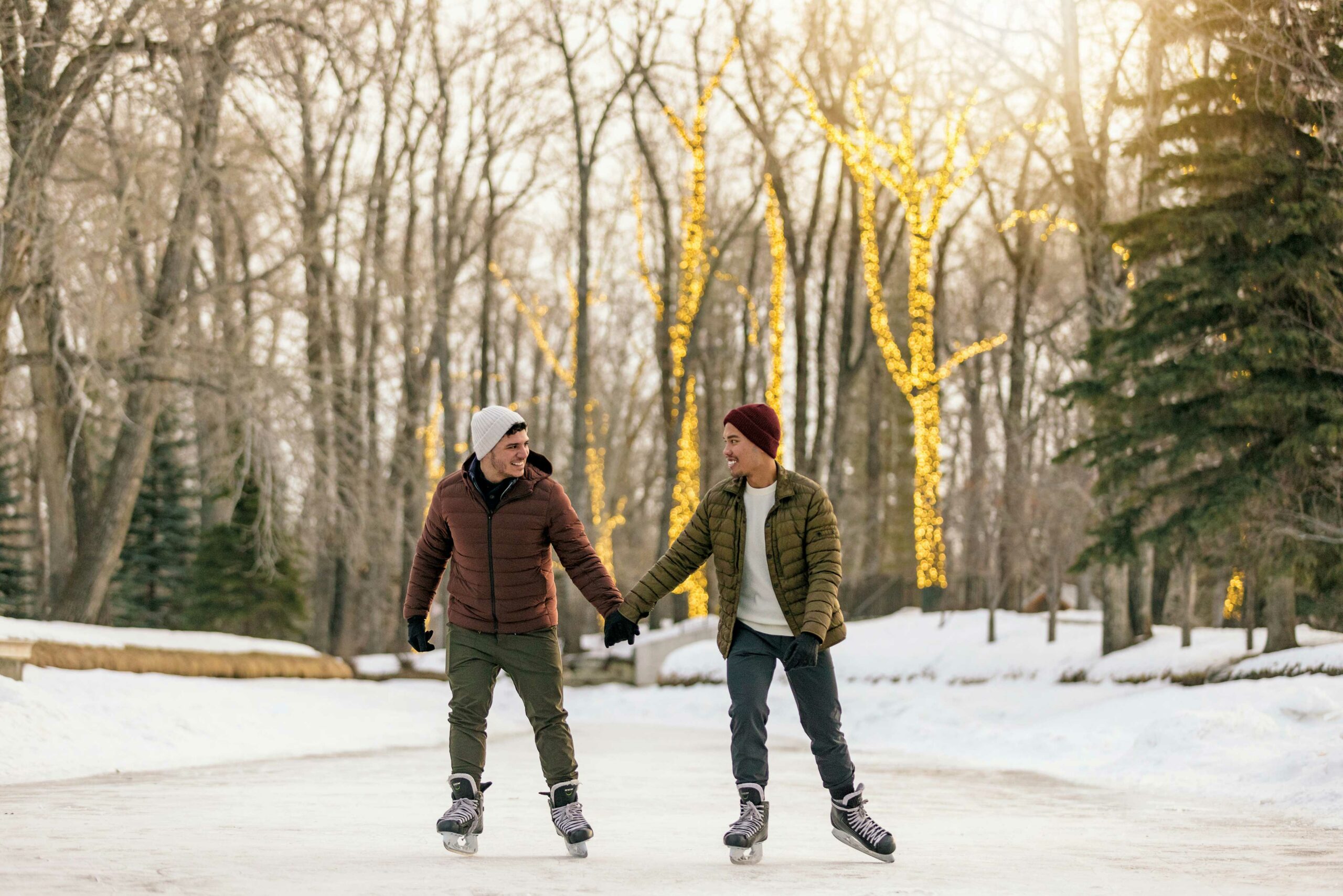 Two people skate and hold hands in Calgary