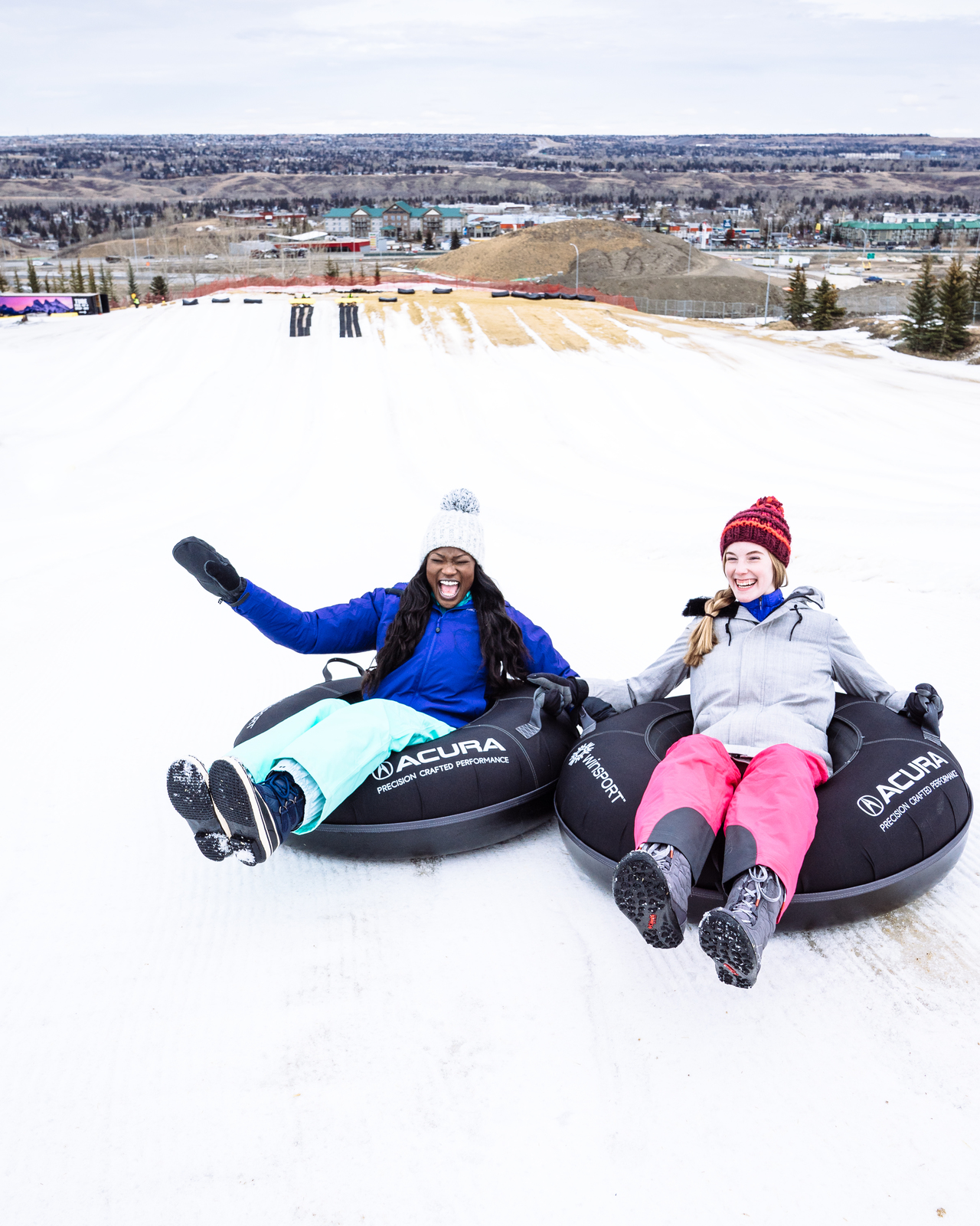 A couple tubing at Winsport COP on a winter date