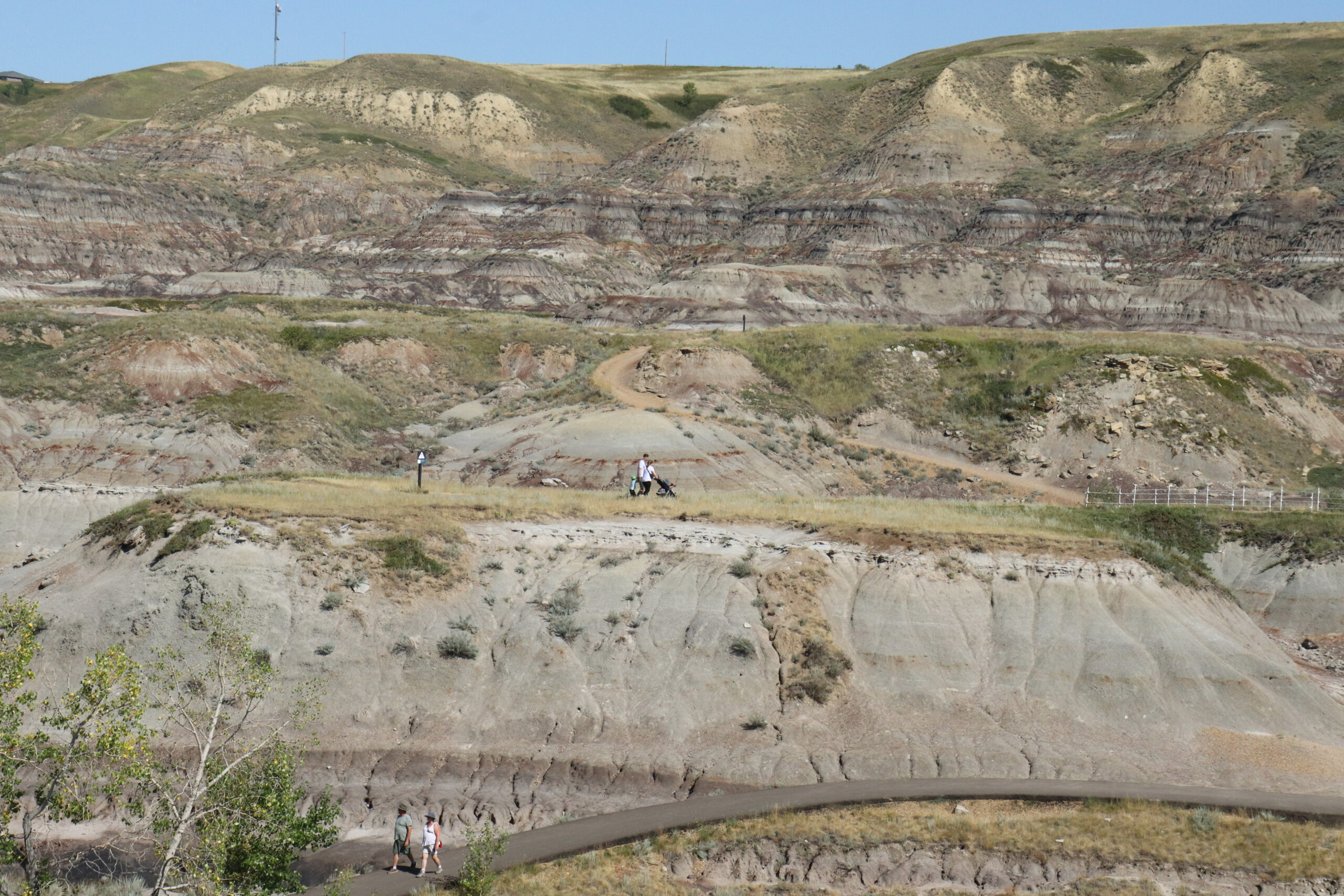 People walk along pathways in the badlands of Drumheller, Alberta. 