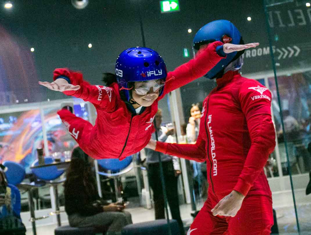 An instructor helps a child in the flight simulator tunnel at iFly in Calgary. 
