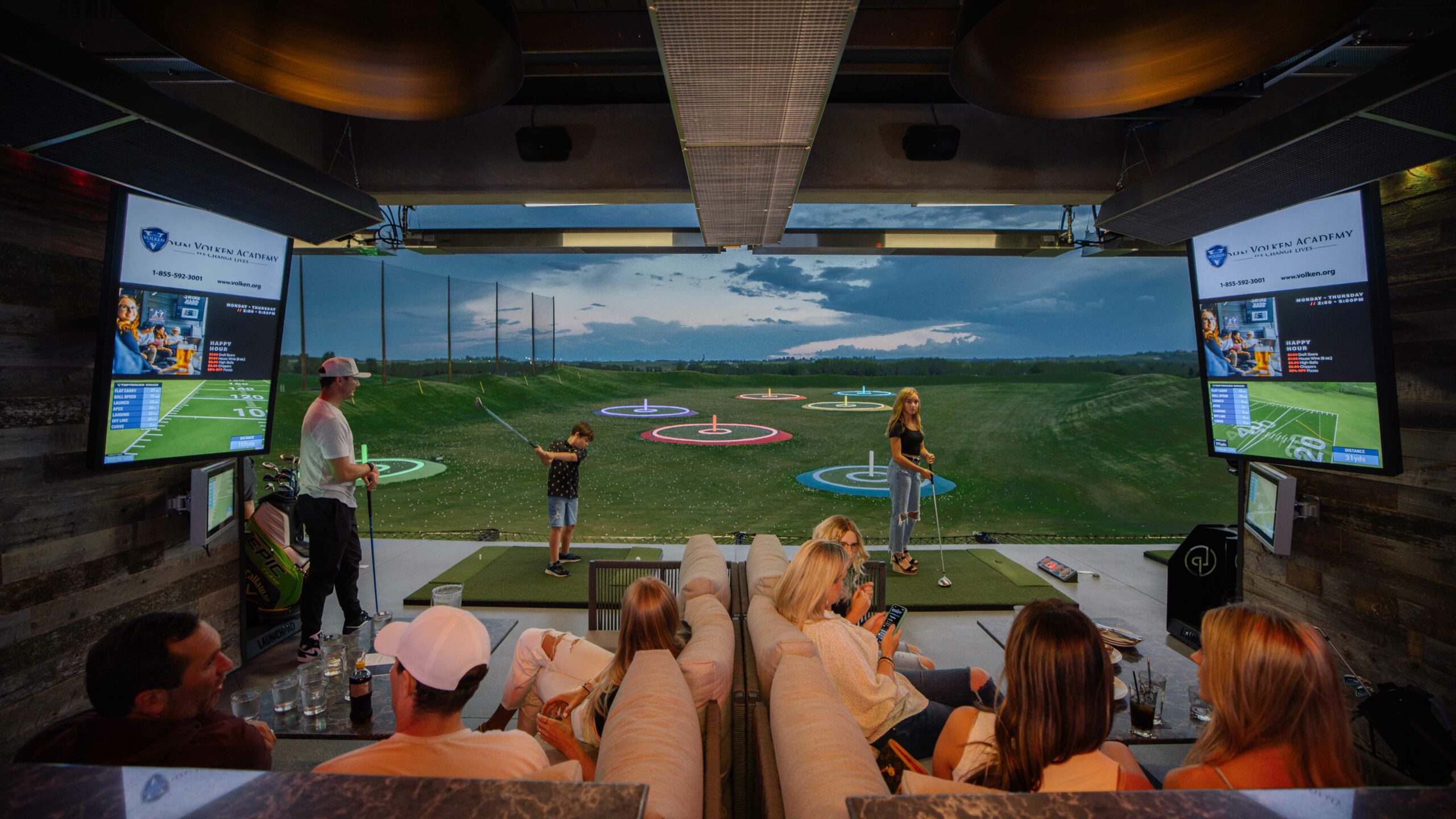 Two people play golf related games at Launch Pad, a great winter activity in Calgary. 