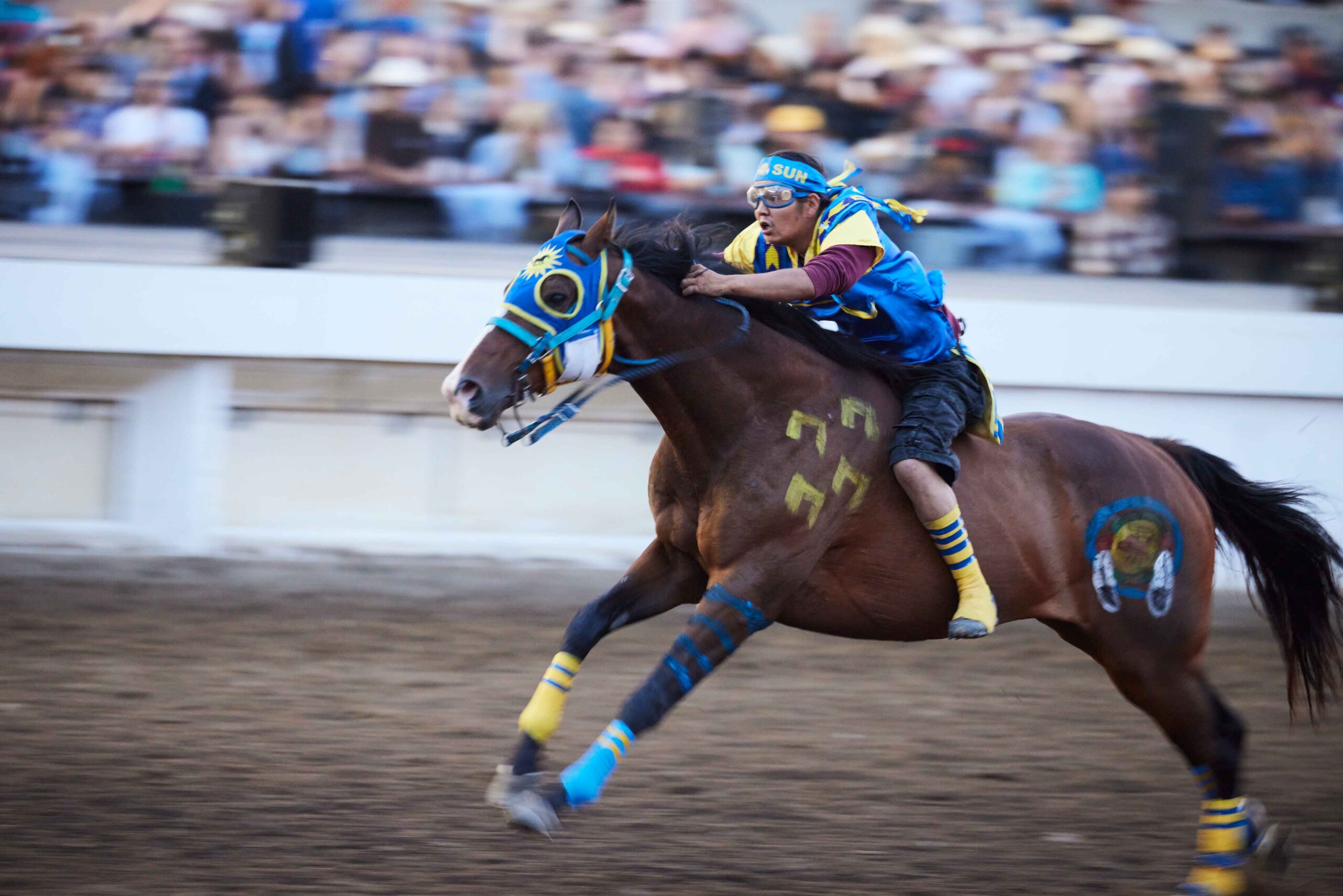 An Indigenous Relay racer takes off on his horse at the Calgary Stampede.